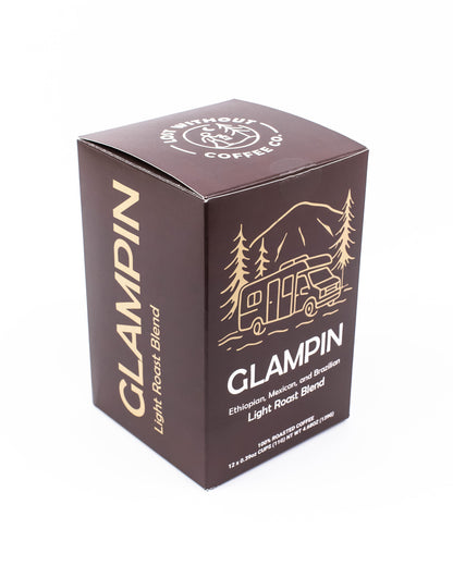 Fresh Roasted Coffee Glampin Light Roast Blend Pods packaging featuring vibrant design and scenic nature elements.