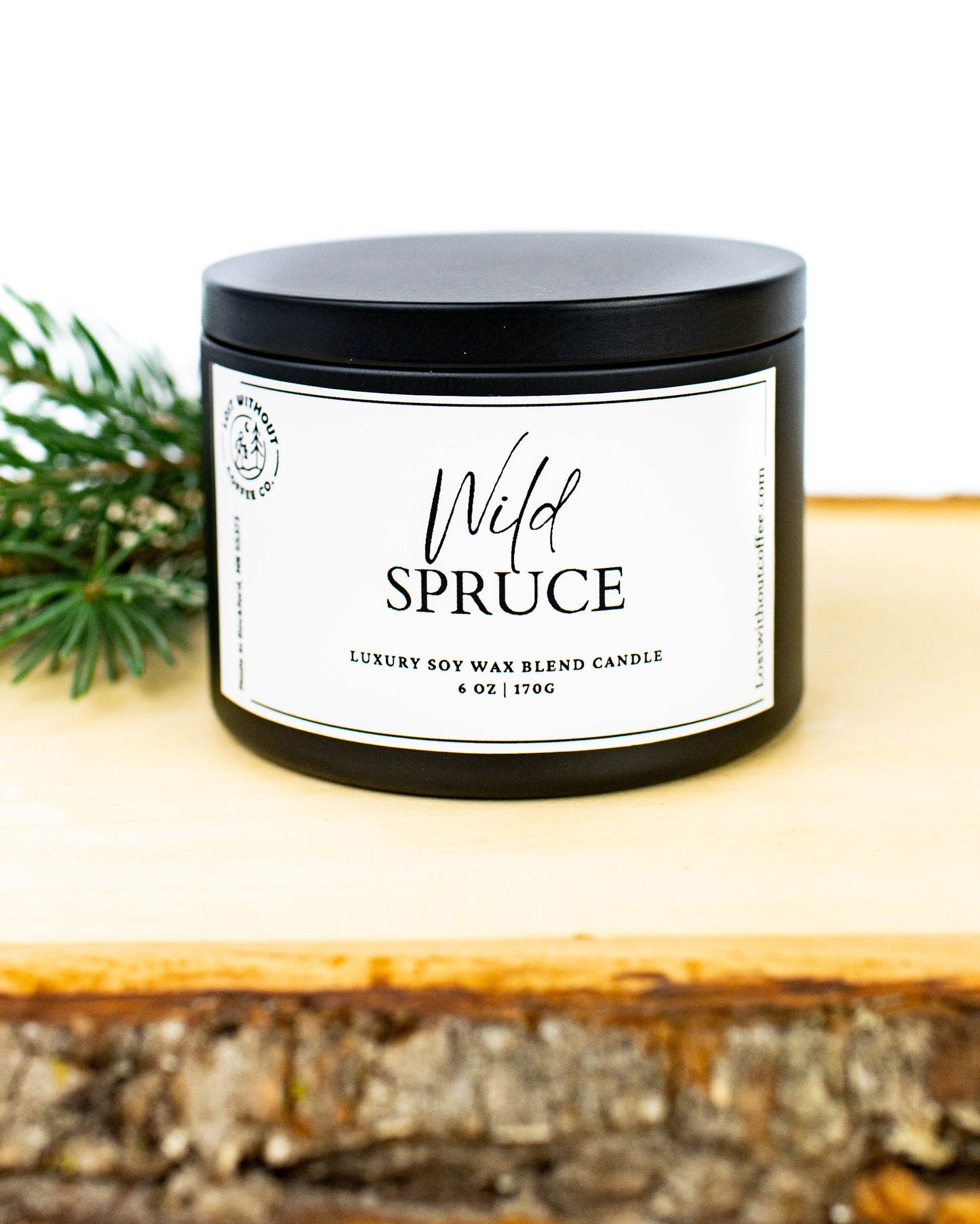 Soy Wax Candles - Wild Spruce 6oz luxury soy wax blend candle with black lid and rustic background.