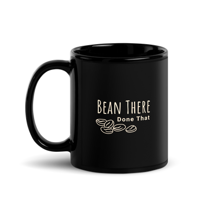 Black ceramic coffee mug featuring the phrase 'Bean There Done That' with coffee bean graphic.